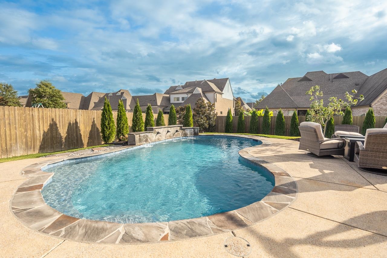 View of pool featuring a patio and pool water feature