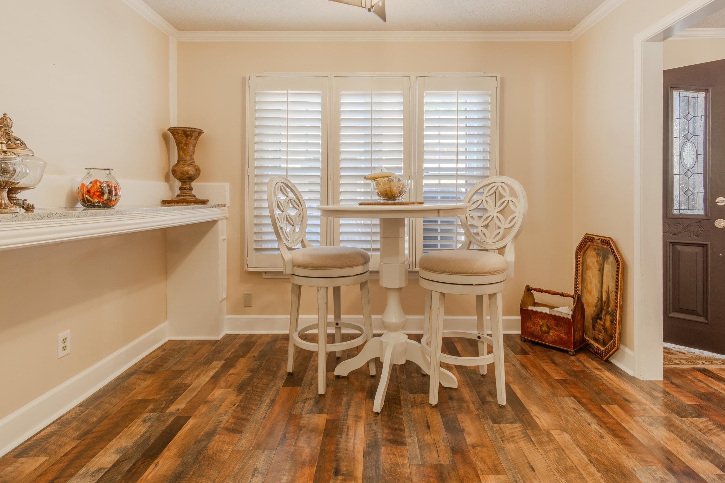 Dining room with dark hardwood / wood-style floors and crown molding