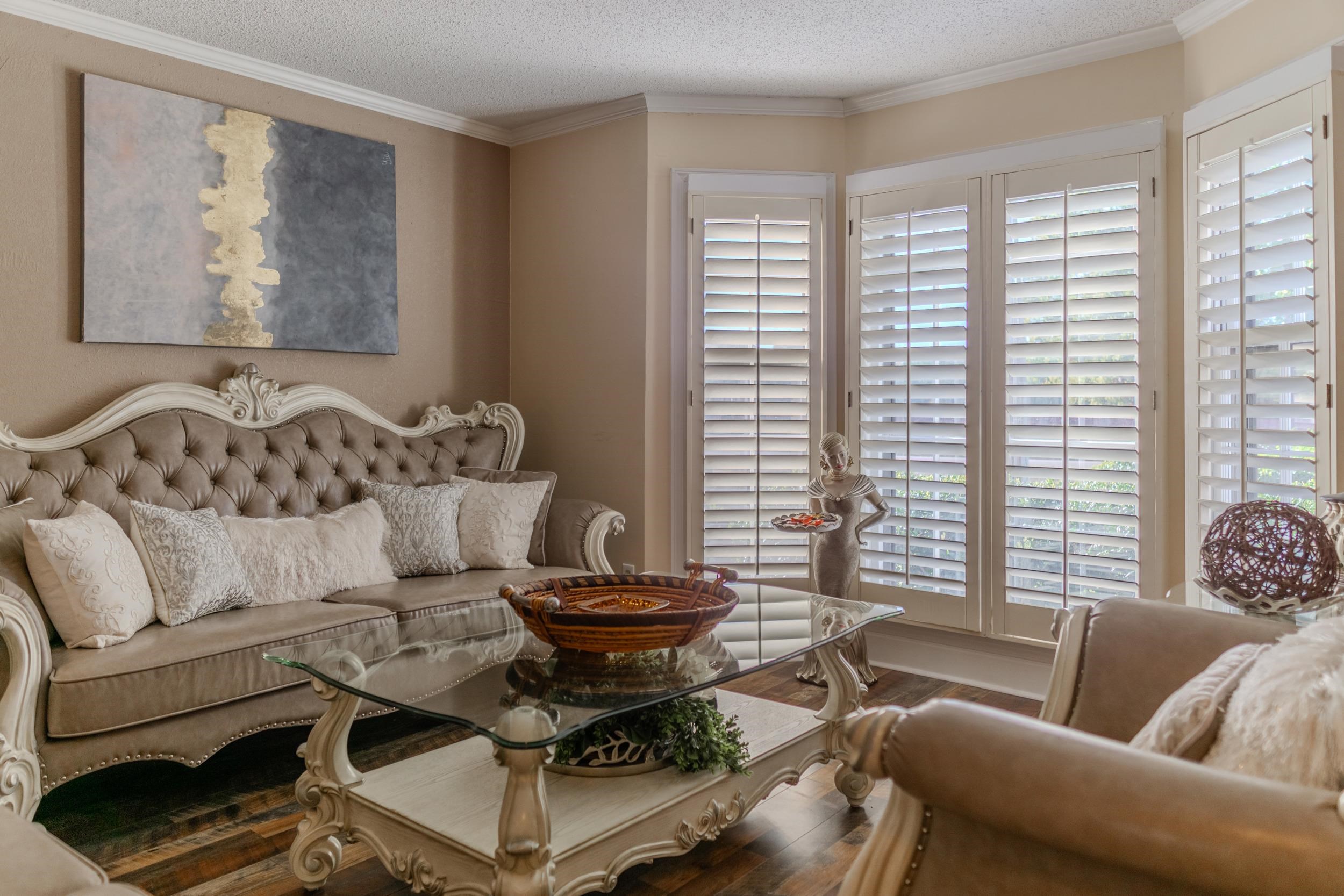 Living room featuring hardwood / wood-style flooring, a textured ceiling, and ornamental molding