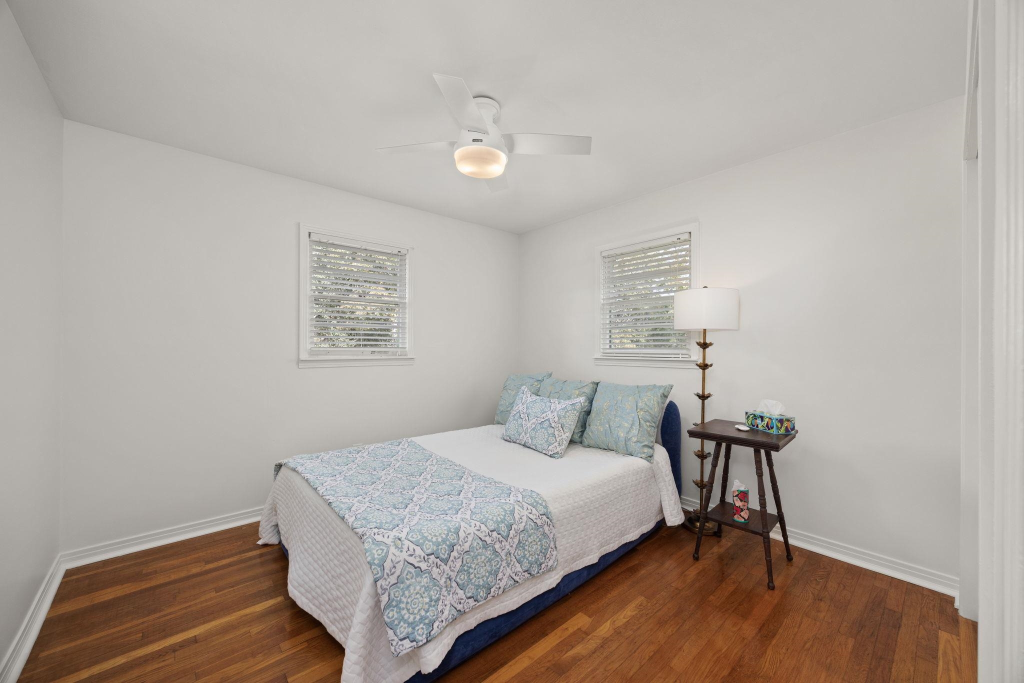 Bedroom featuring dark wood-type flooring and ceiling fan