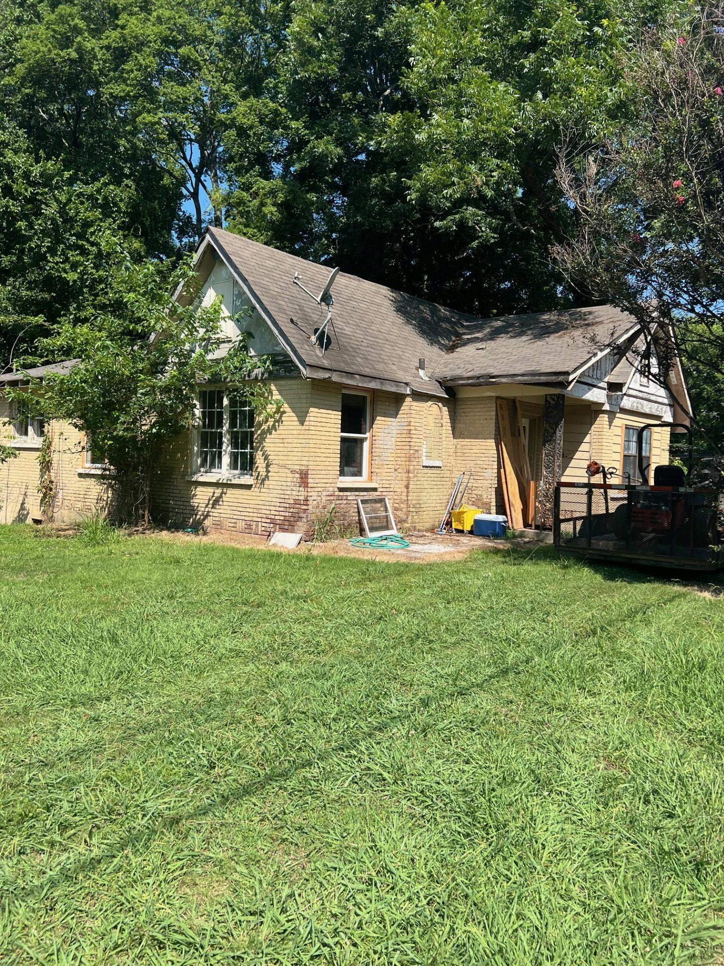 Rear view of house featuring a yard