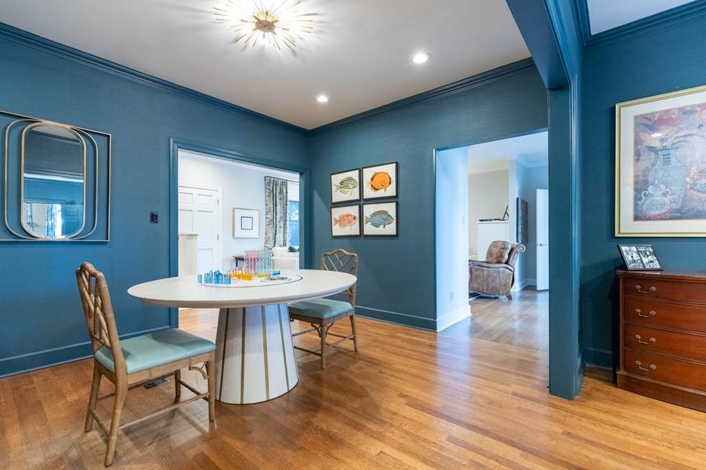 Dining room featuring light wood-type flooring and crown molding