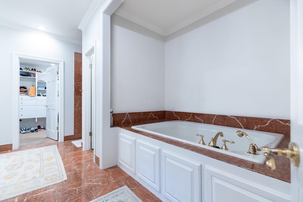 Bathroom featuring a bathtub and ornamental molding