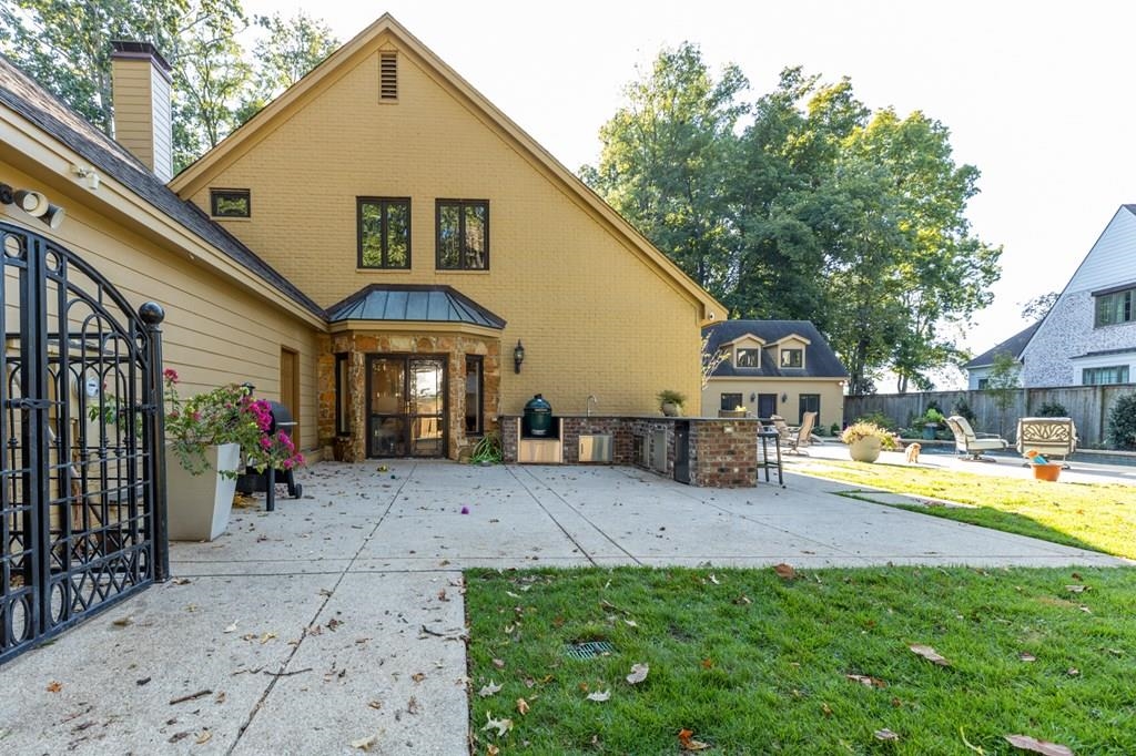 Back of property featuring a patio and a yard
