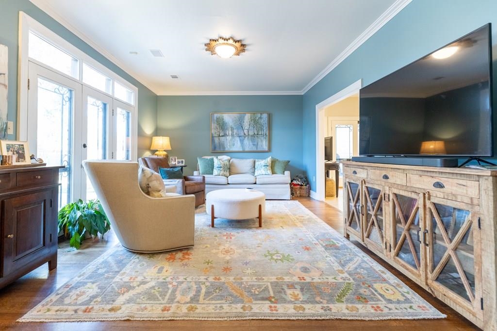 Living room featuring hardwood / wood-style floors, french doors, and ornamental molding