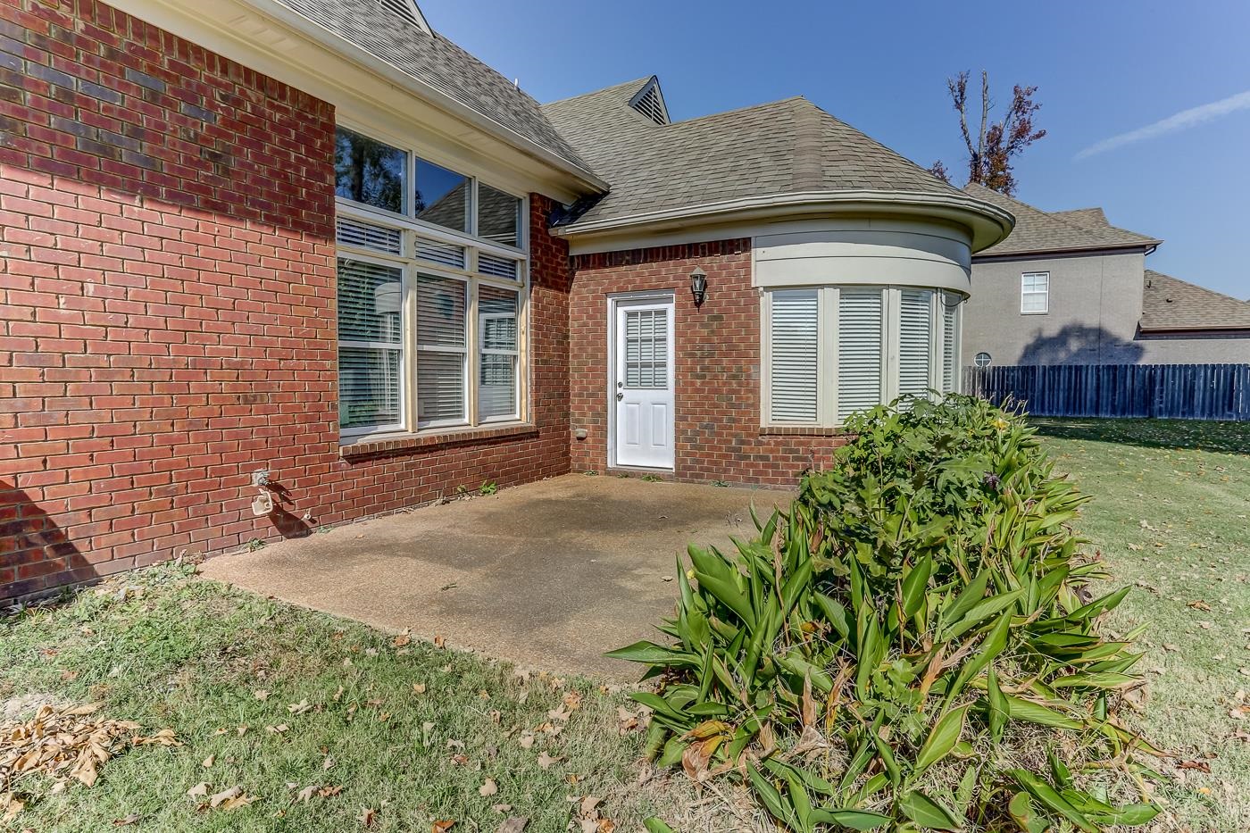 Doorway to property with a yard and a patio