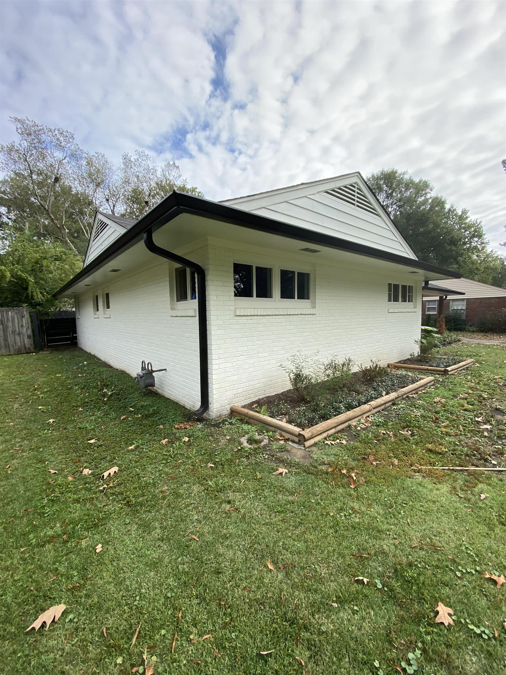 View of home\'s exterior with a yard