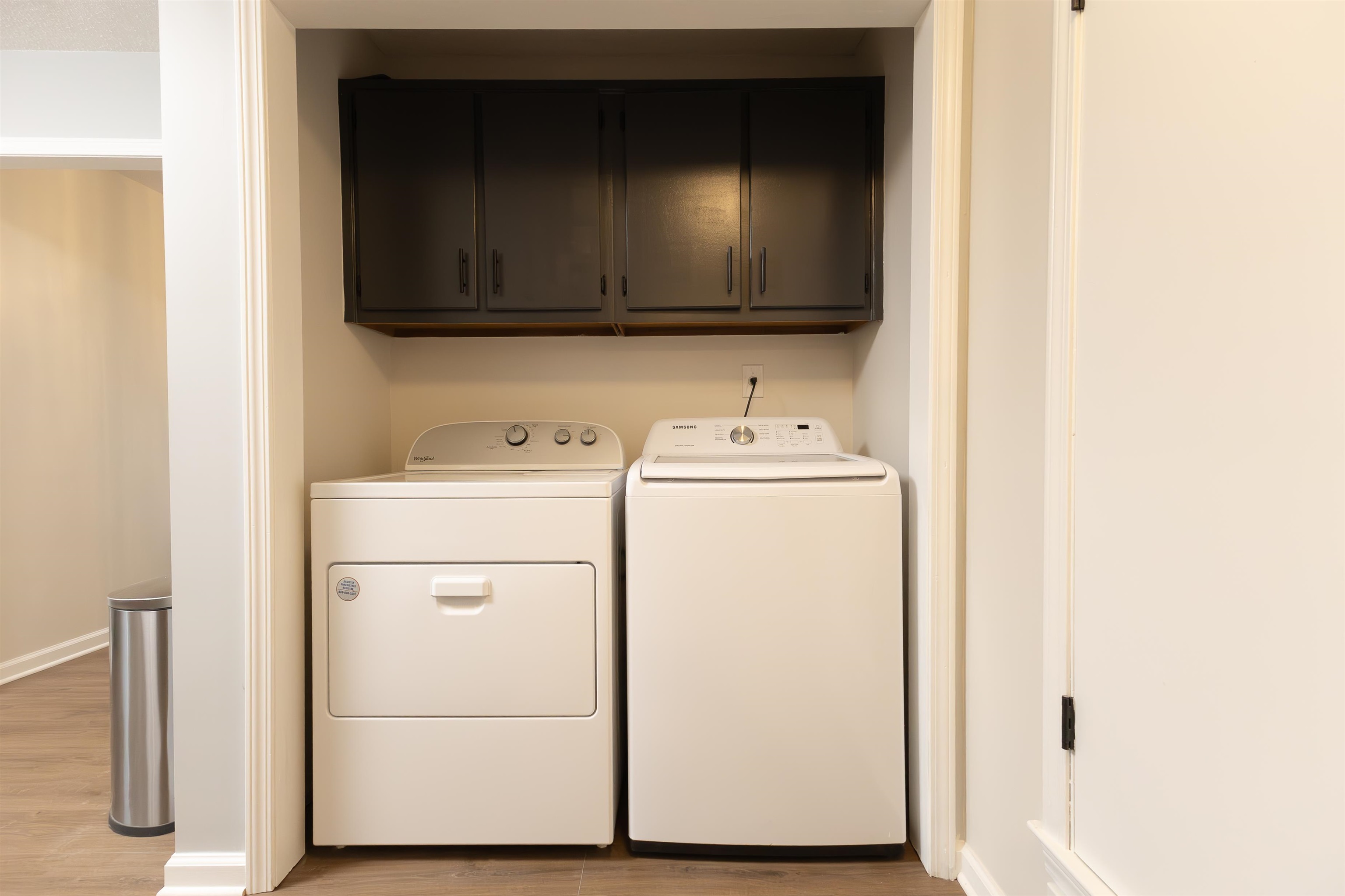 Laundry room featuring cabinets, light hardwood / wood-style floors, and washer and clothes dryer