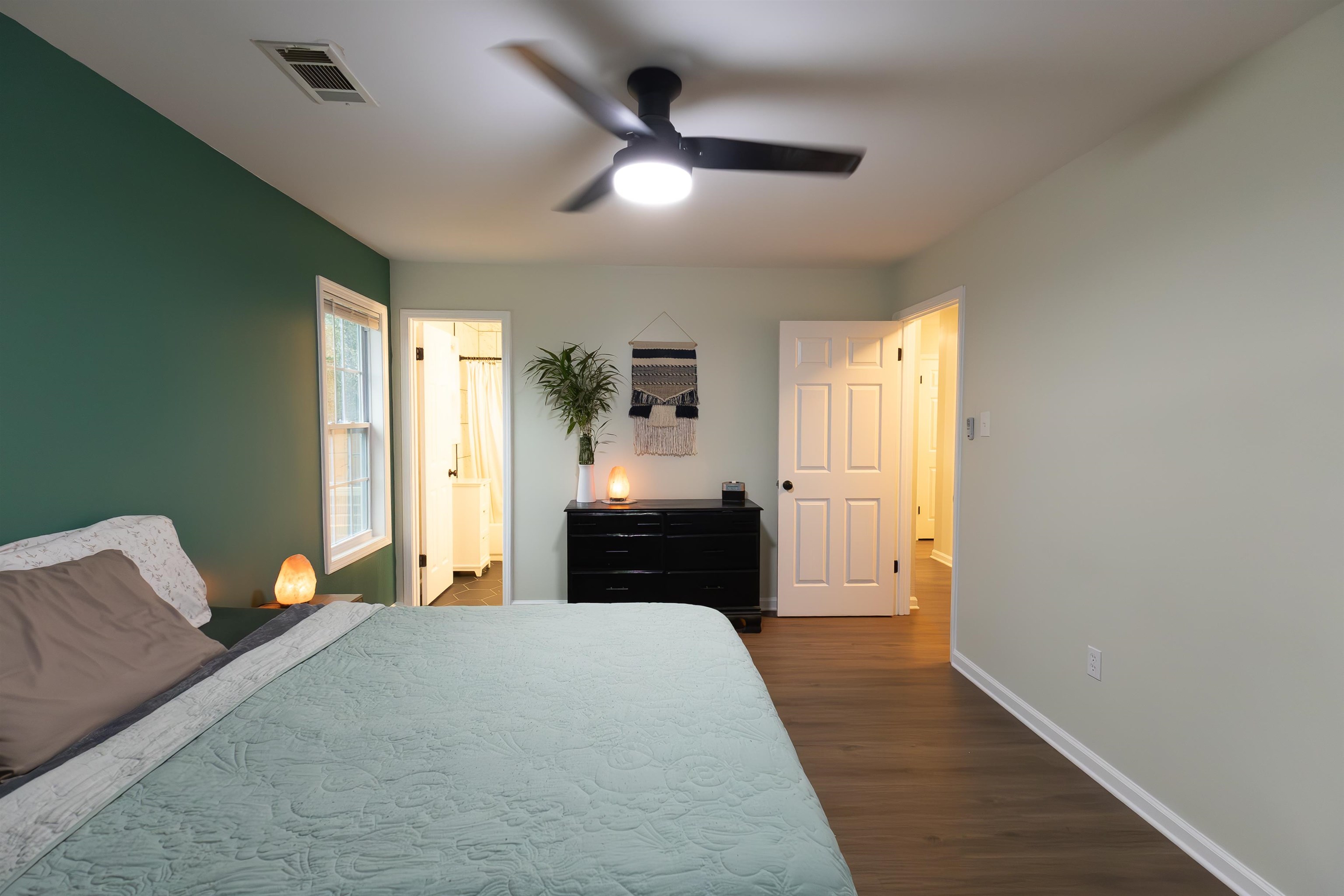 Bedroom featuring ceiling fan and dark hardwood / wood-style floors