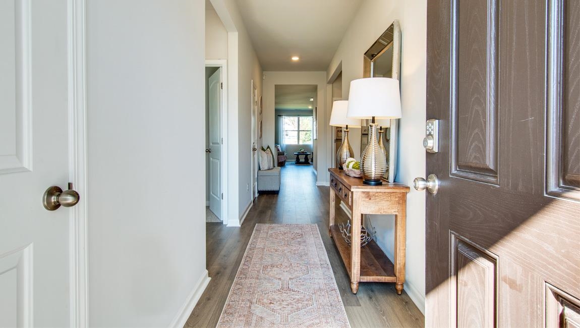 Hallway with dark hardwood / wood-style floors