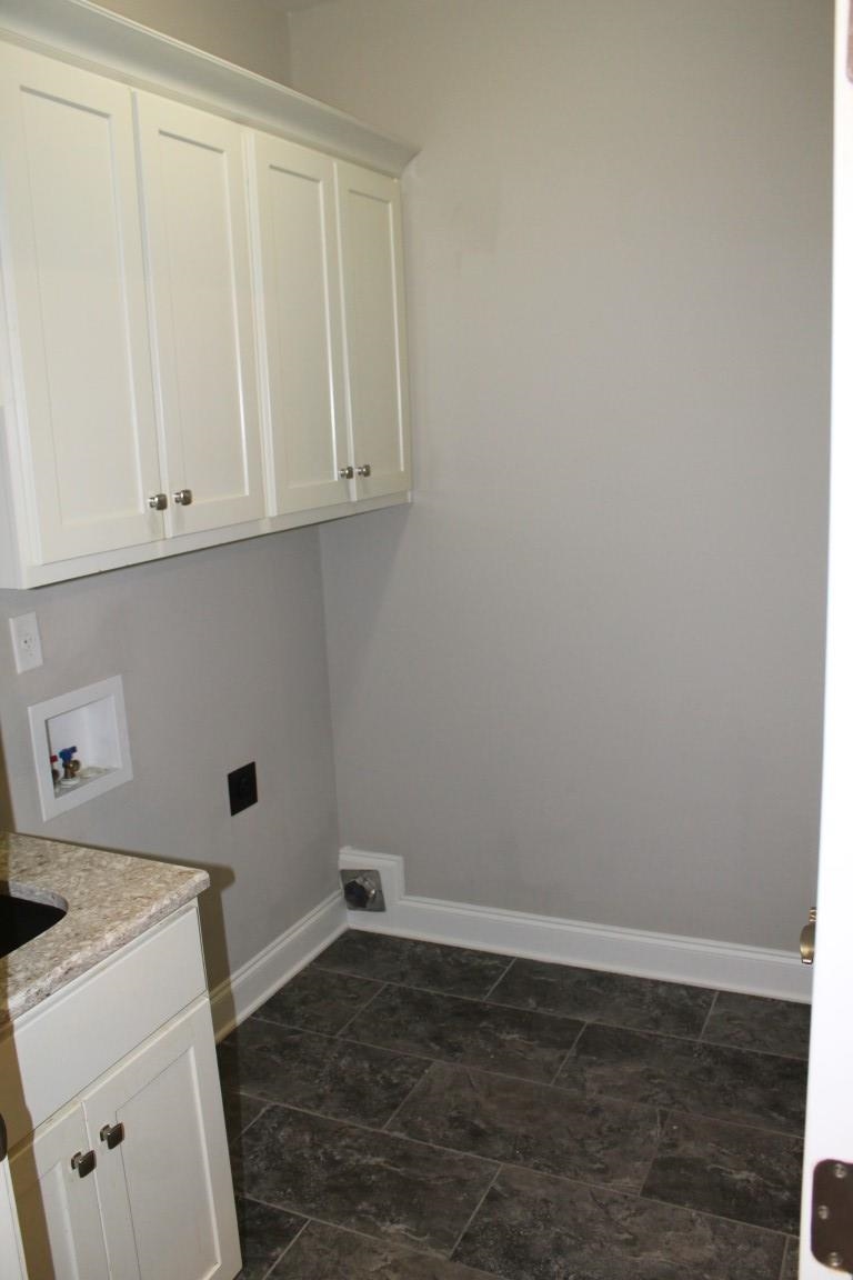 Clothes washing area with hookup for a washing machine and cabinets