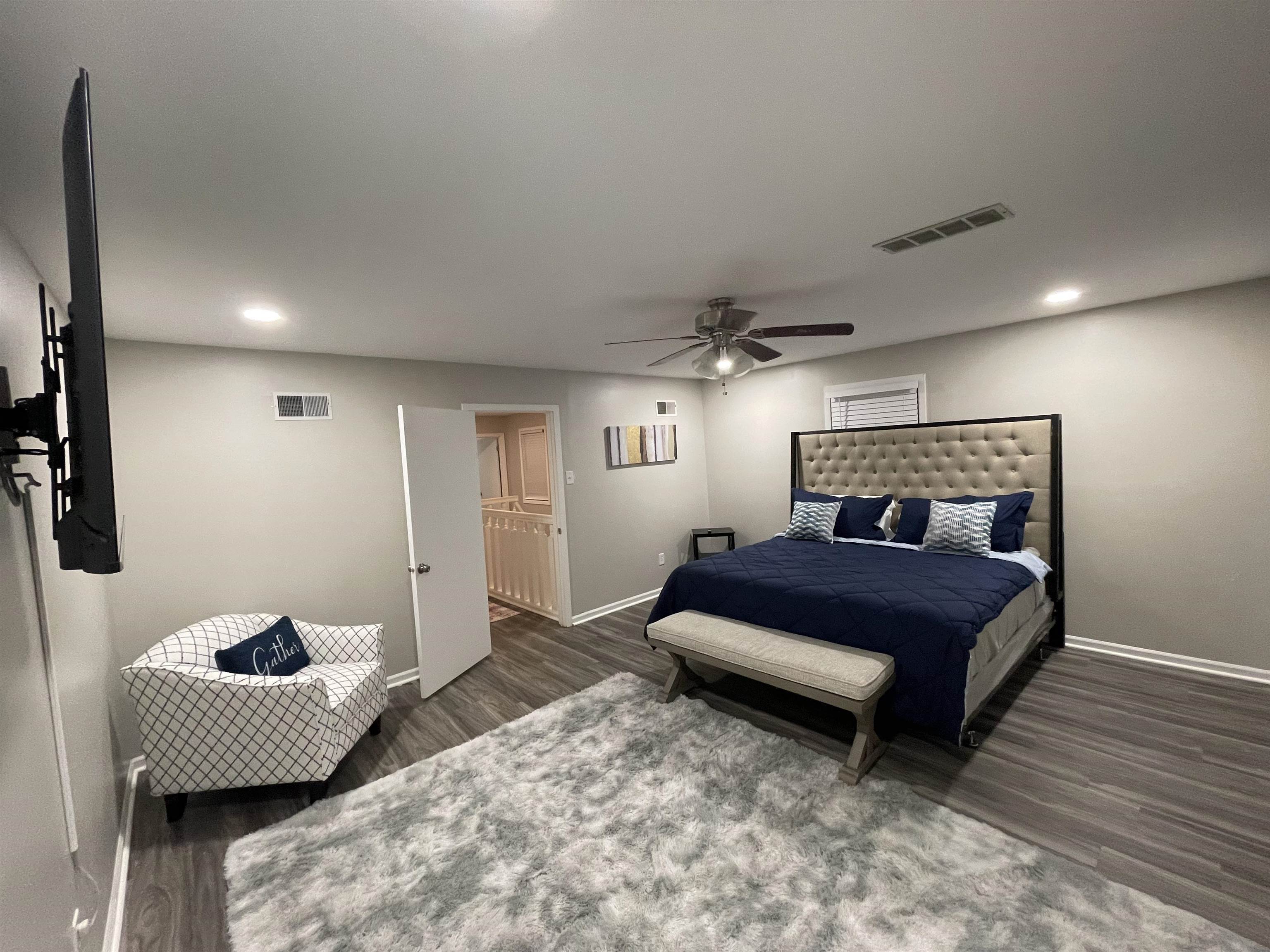 Bedroom with dark wood-type flooring and ceiling fan