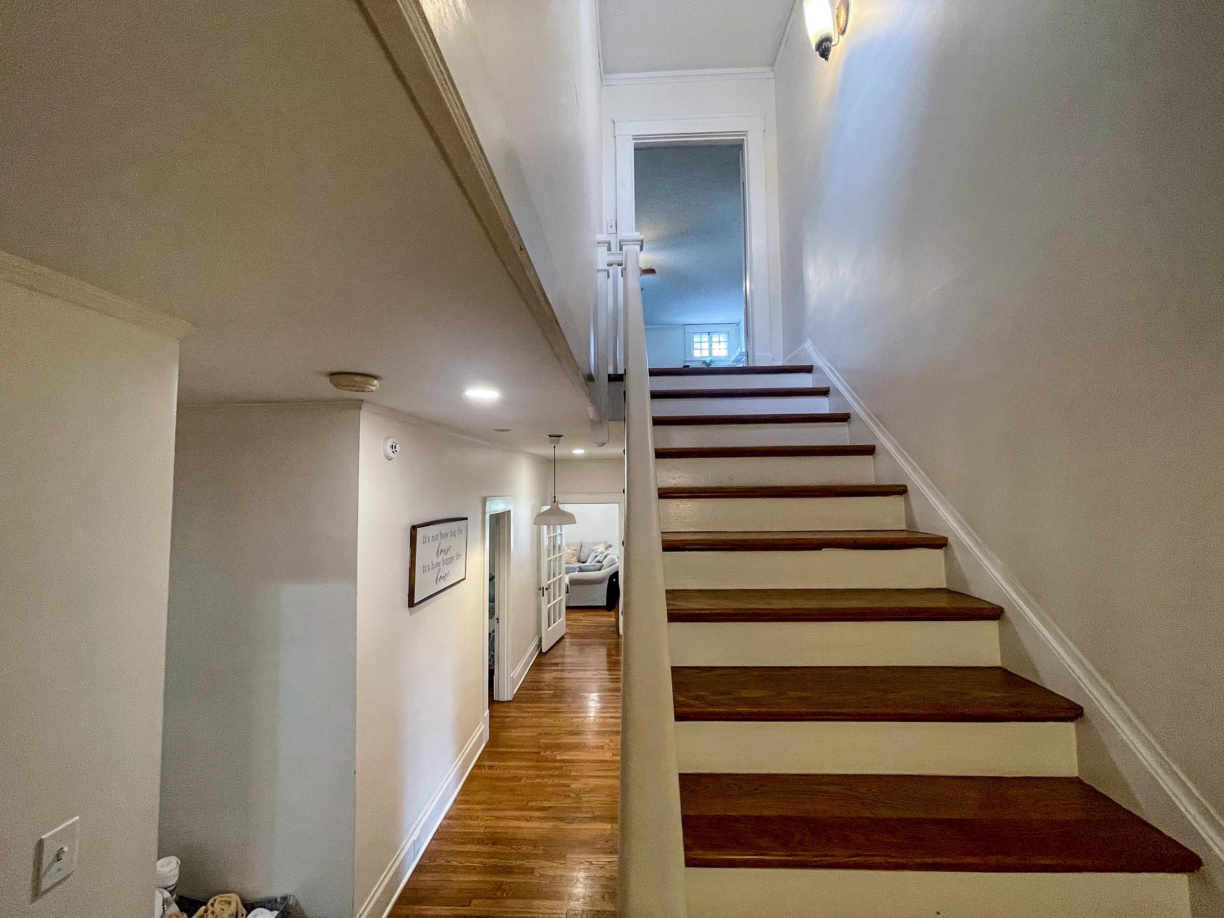 Stairs with ornamental molding and wood-type flooring