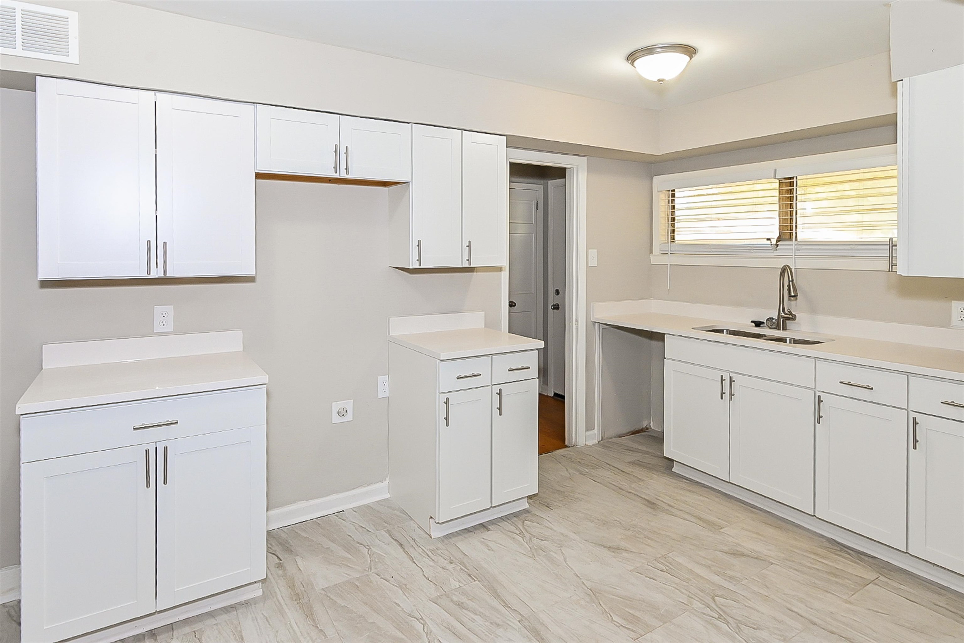 Kitchen with white cabinets and sink