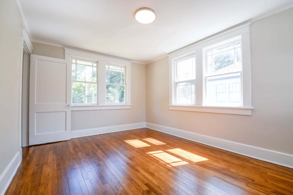 Unfurnished room with dark hardwood / wood-style flooring and ornamental molding