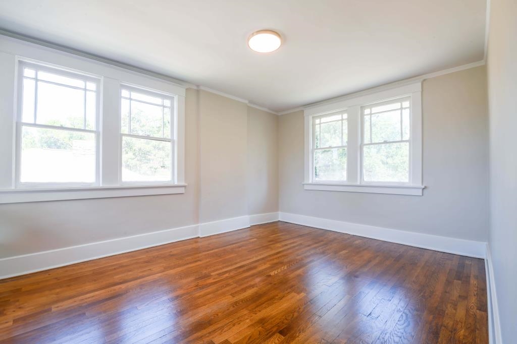 Unfurnished room featuring dark hardwood / wood-style flooring and ornamental molding