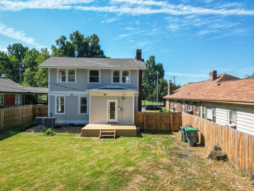 Rear view of house featuring a yard