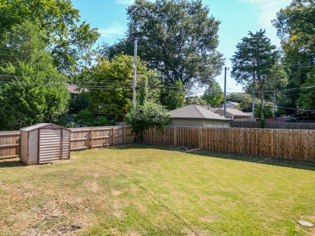 View of yard with a storage unit
