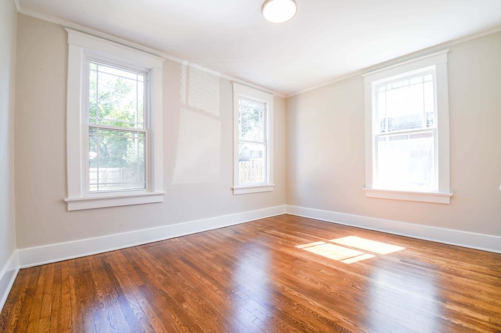 Unfurnished room featuring hardwood / wood-style floors and crown molding