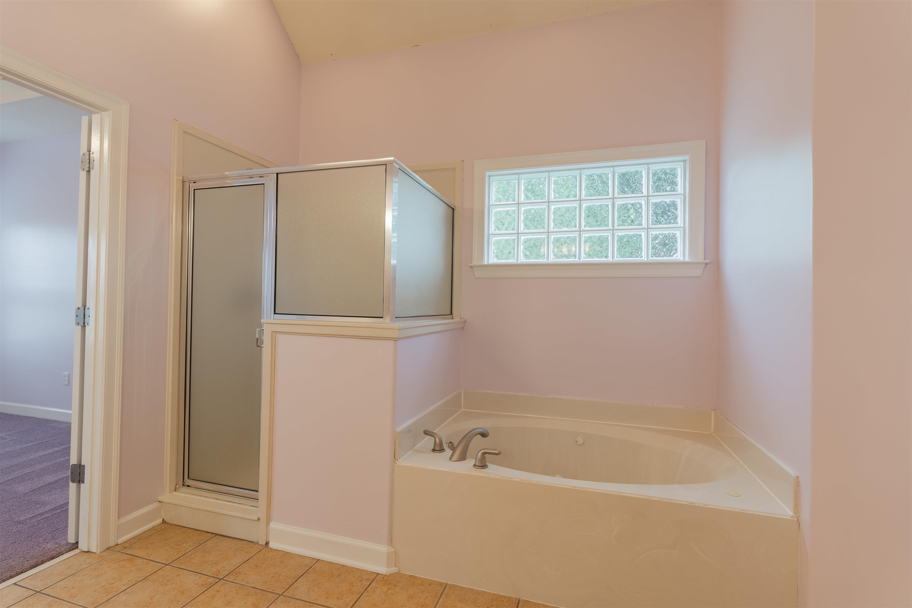 Bathroom featuring tile patterned floors and separate shower and tub