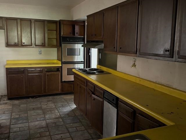 Kitchen with stainless steel appliances and dark brown cabinets