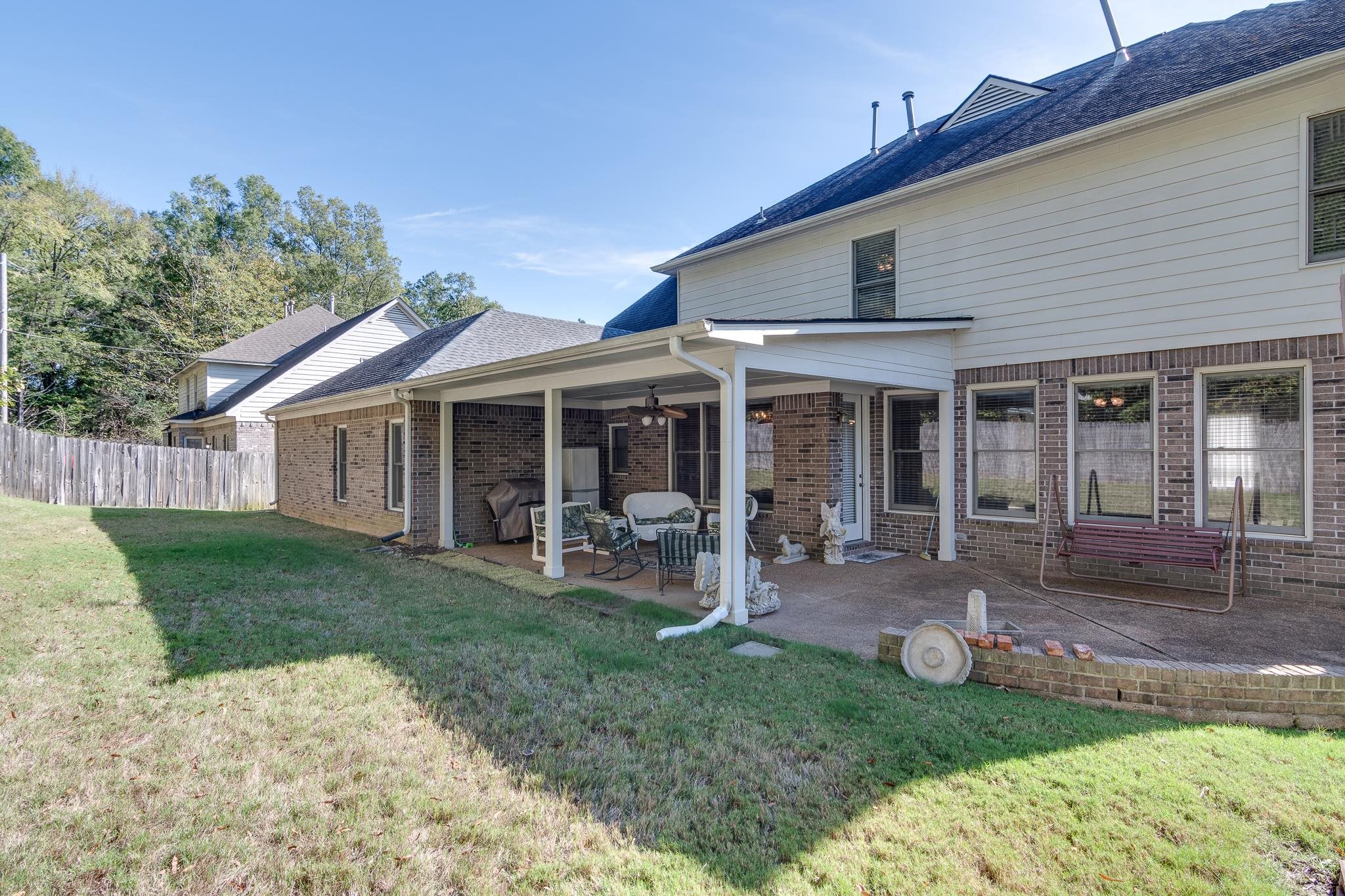 Rear view of house with a lawn, a patio, and ceiling fan