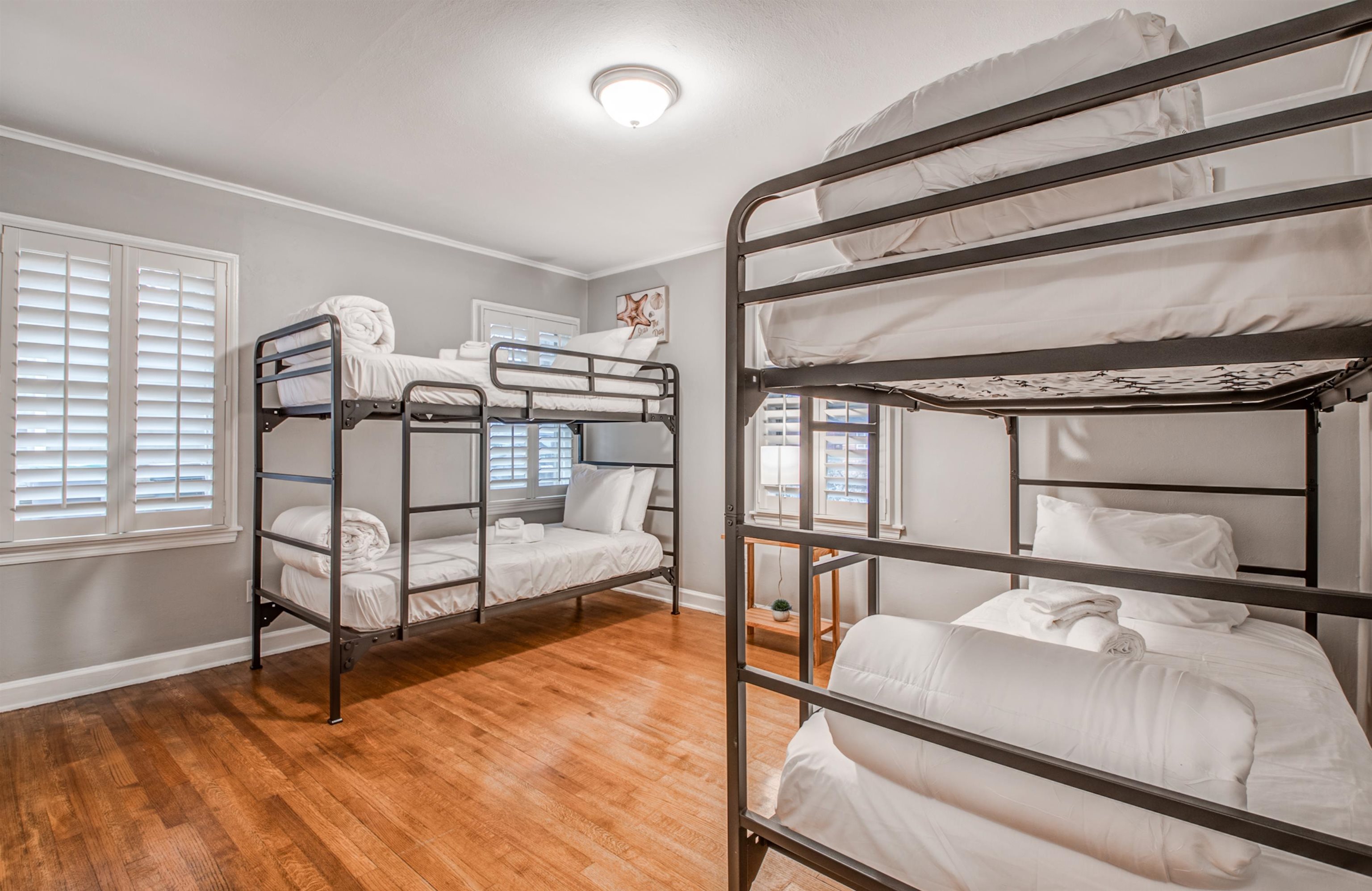 Bedroom with hardwood / wood-style flooring and ornamental molding