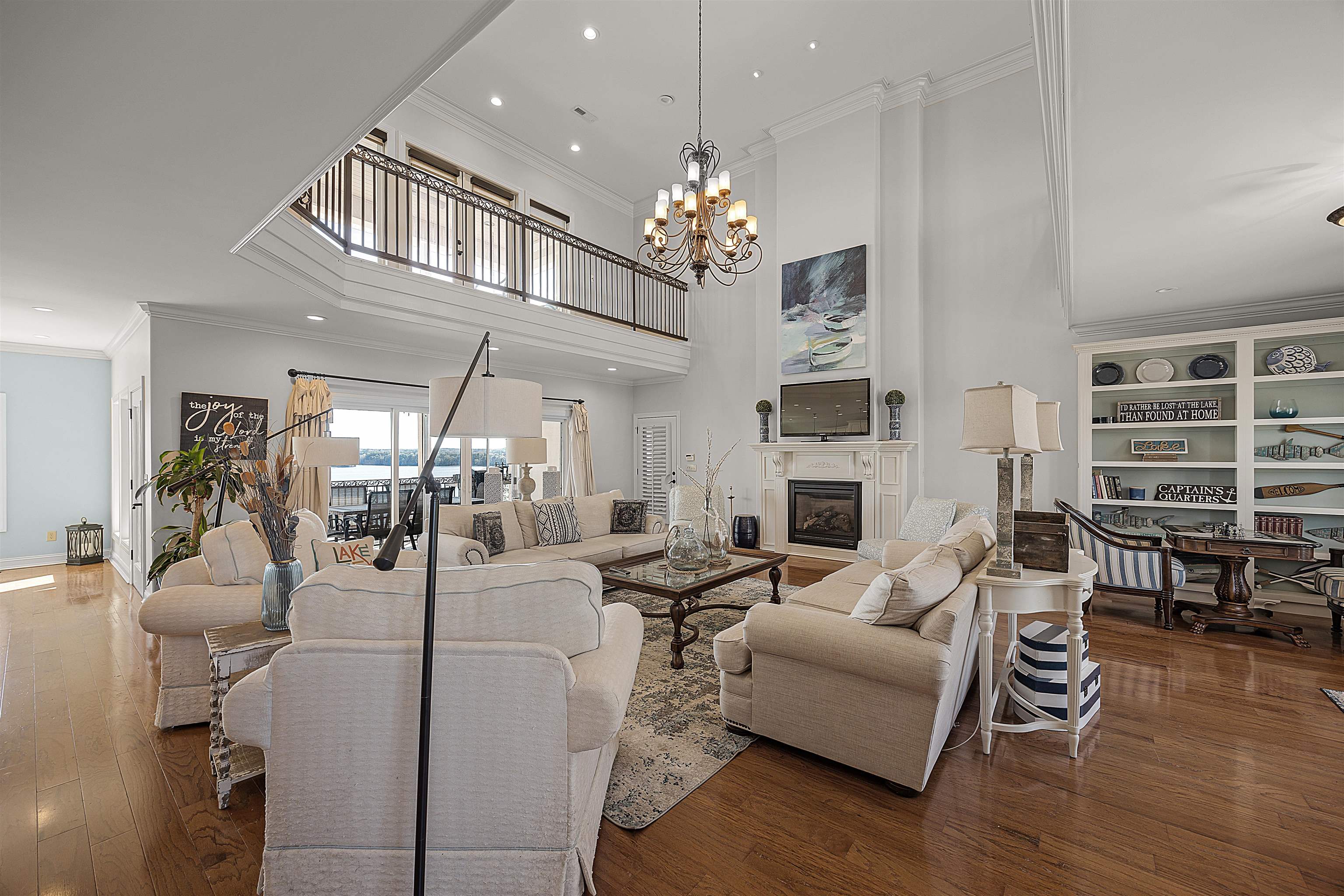 Living room featuring dark hardwood / wood-style floors, a chandelier, and ornamental molding