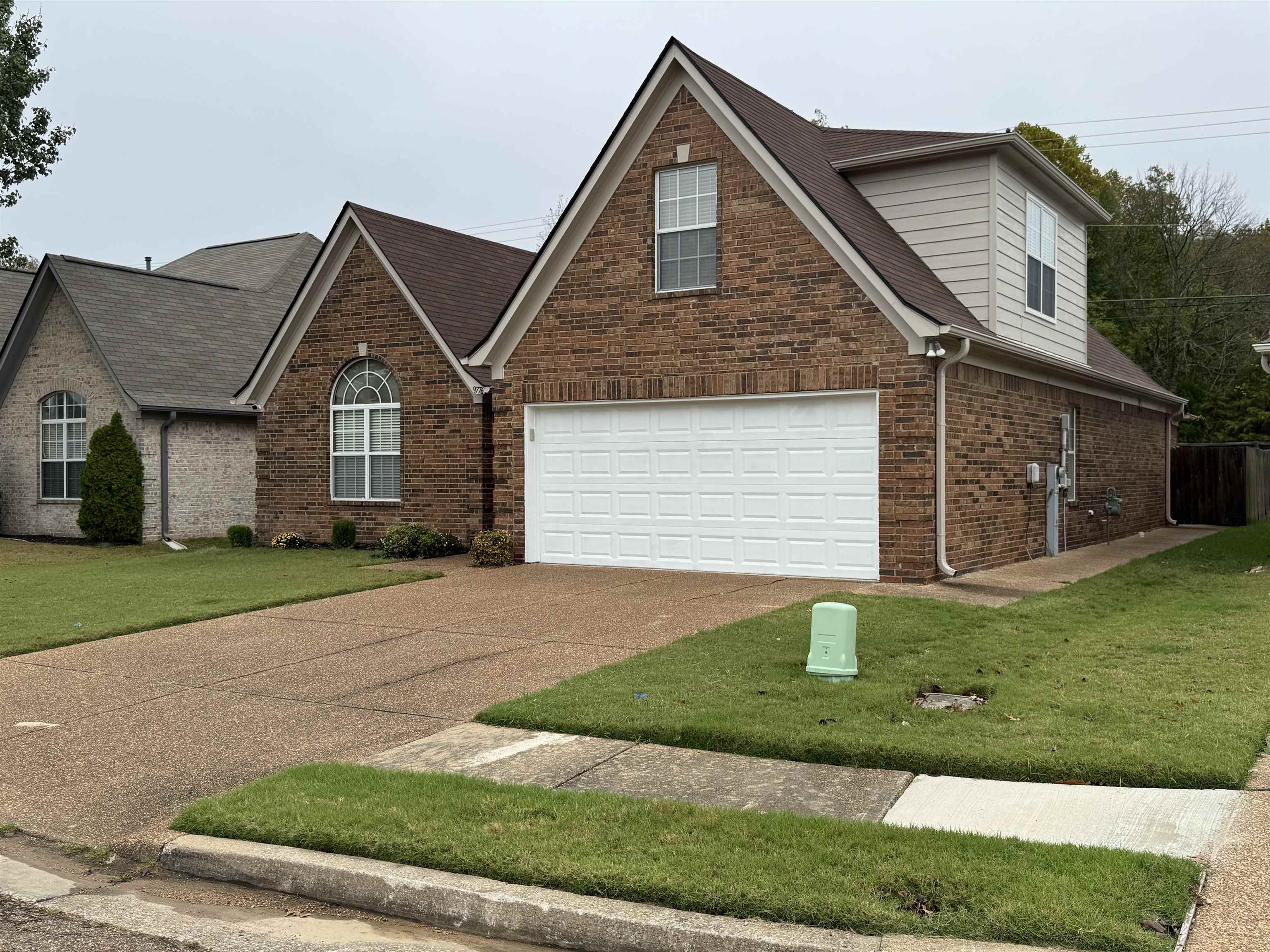 View of front of home featuring a garage and a front yard