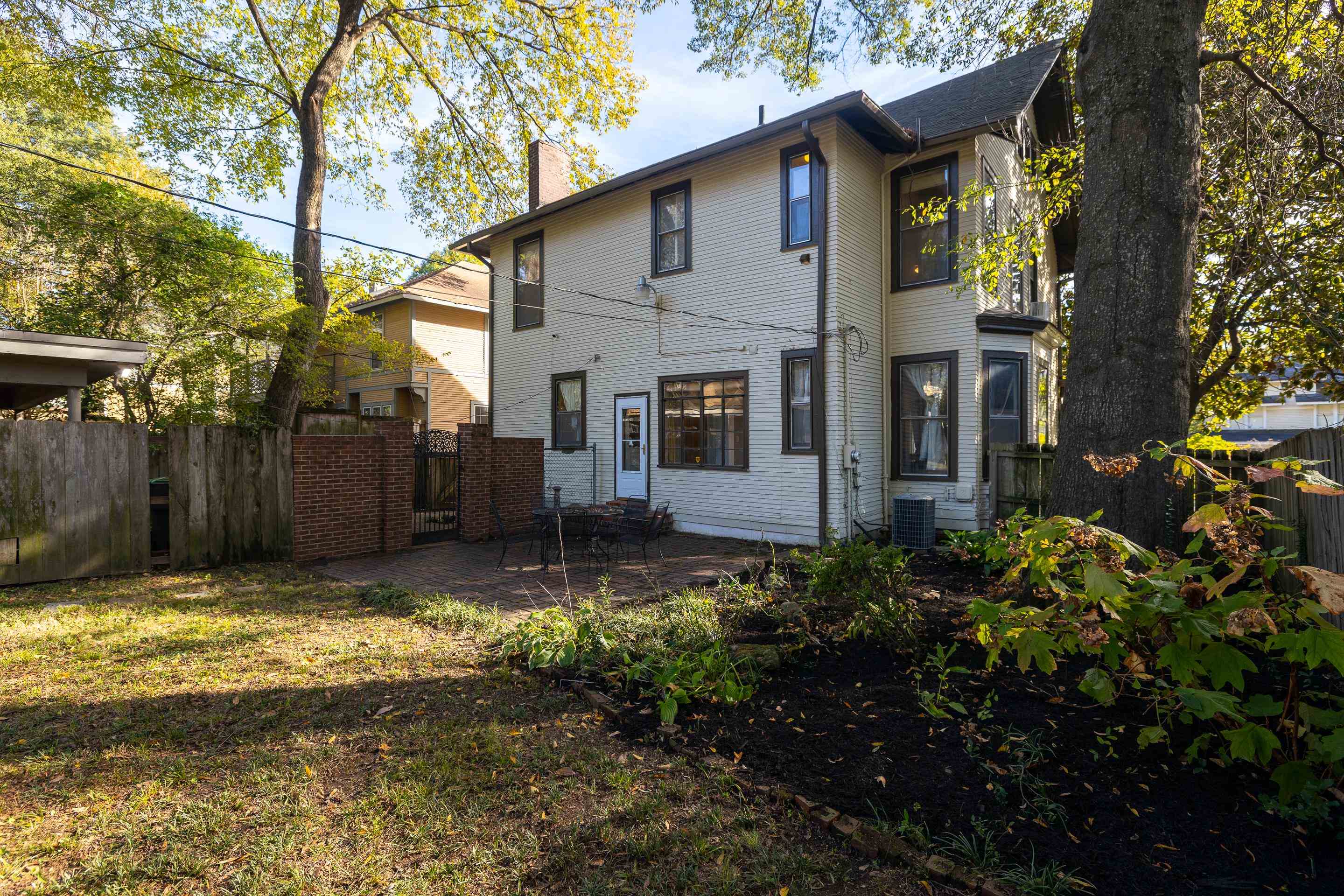 Back of house featuring a patio, central AC, and a lawn