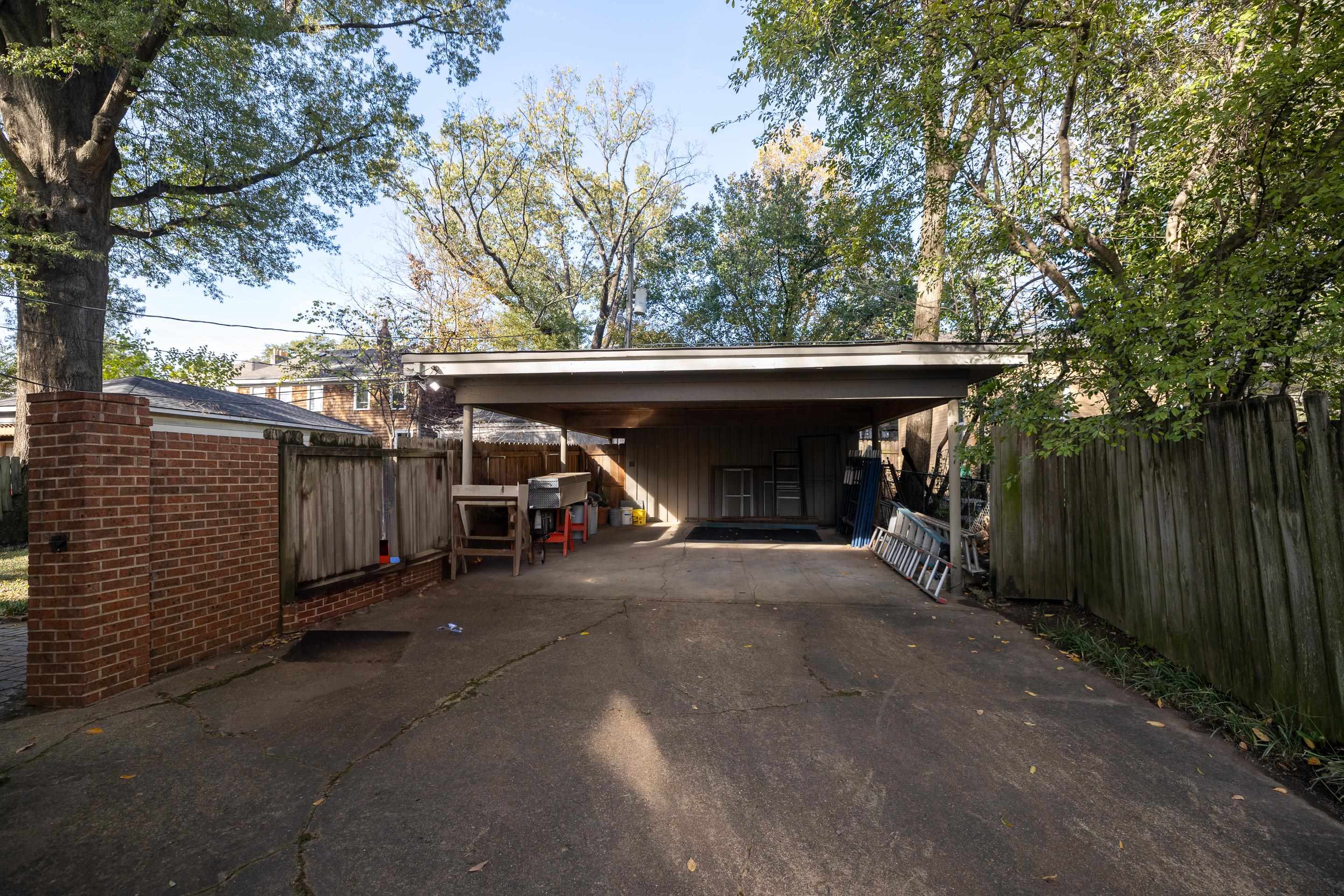 View of parking featuring a carport