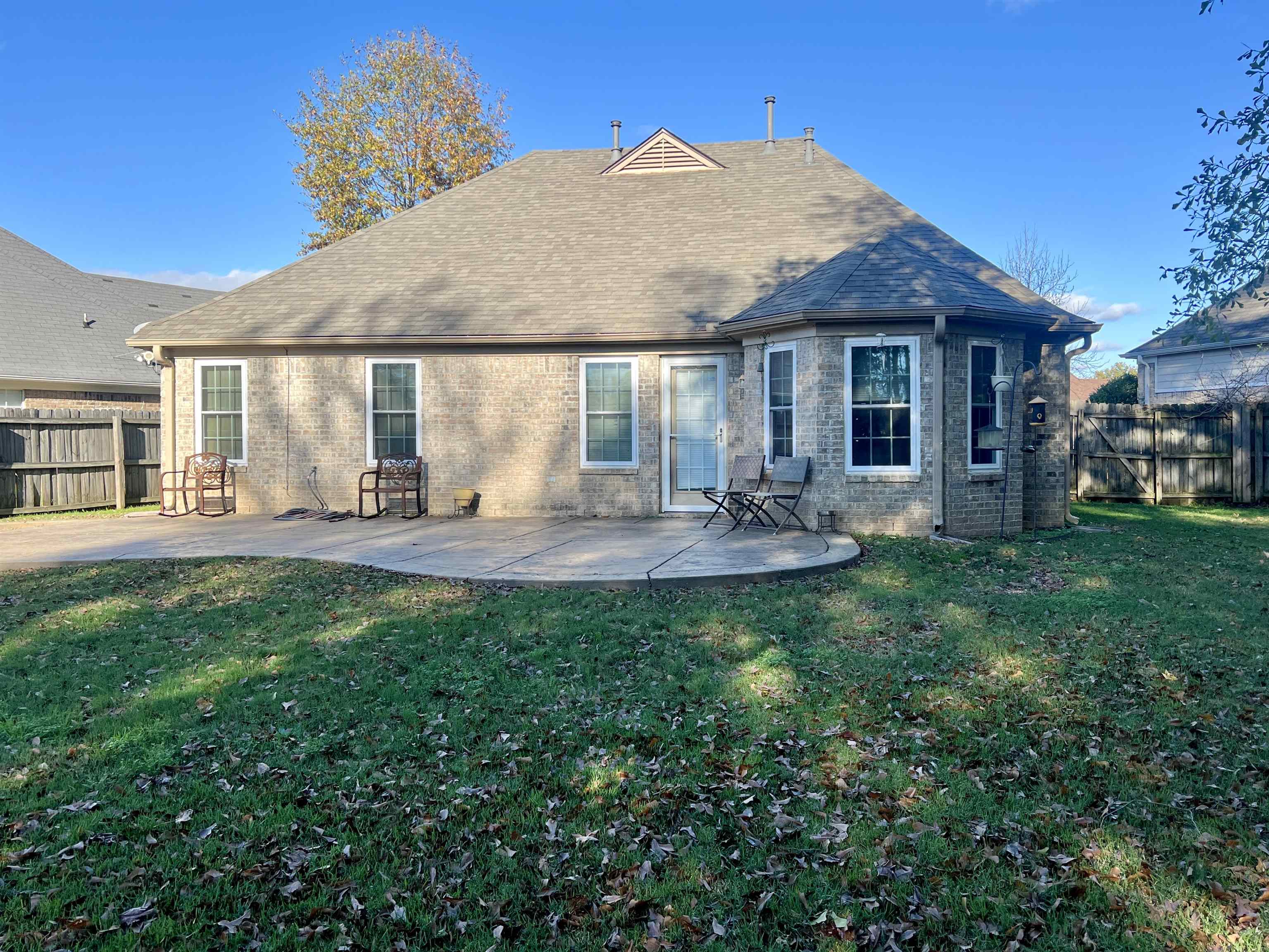 Back of house with a patio area and a yard