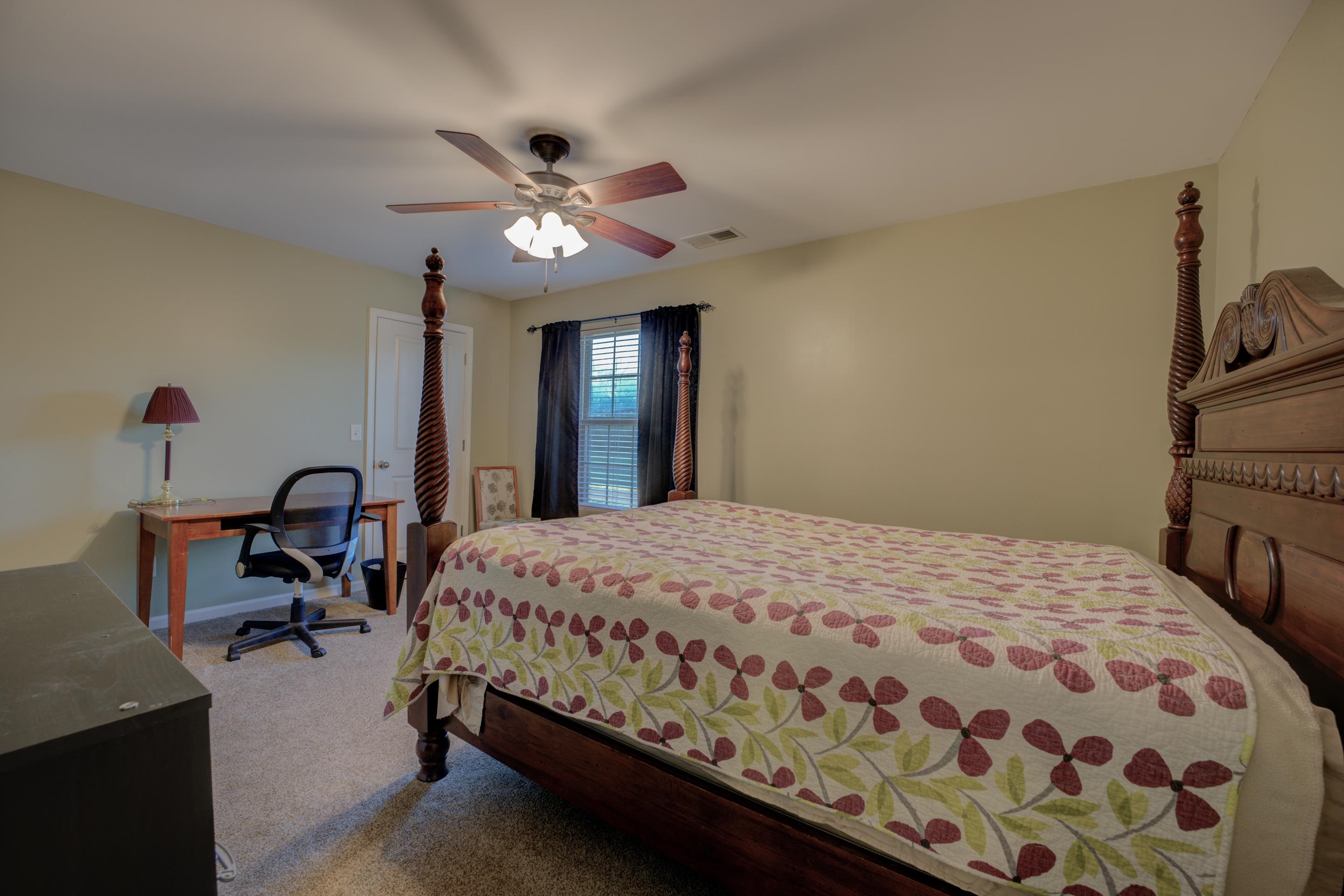 Bedroom featuring carpet floors, closet, and ceiling fan.