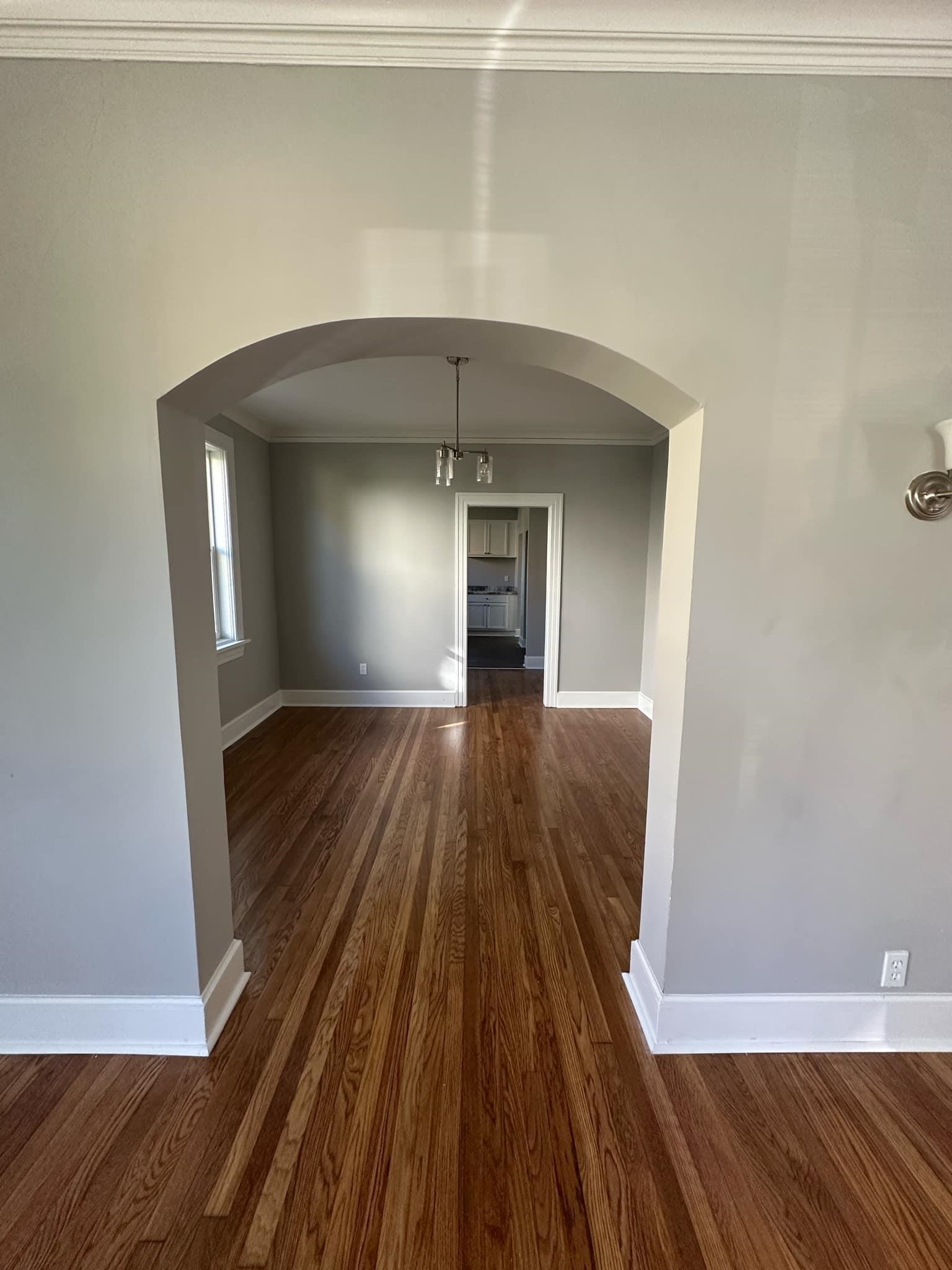 Interior space with dark hardwood / wood-style floors, ornamental molding, and a chandelier