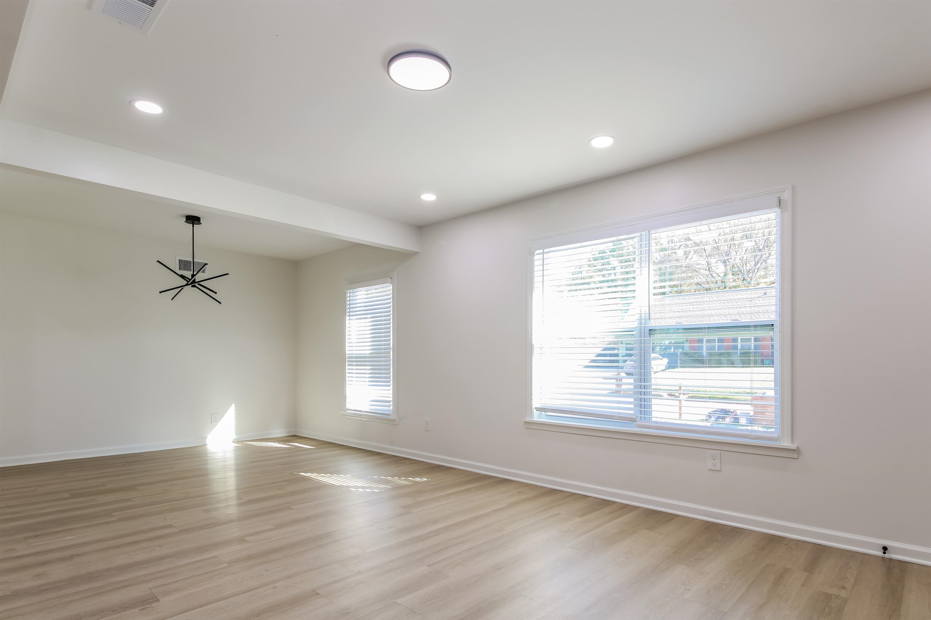 Spare room featuring plenty of natural light and light hardwood / wood-style flooring