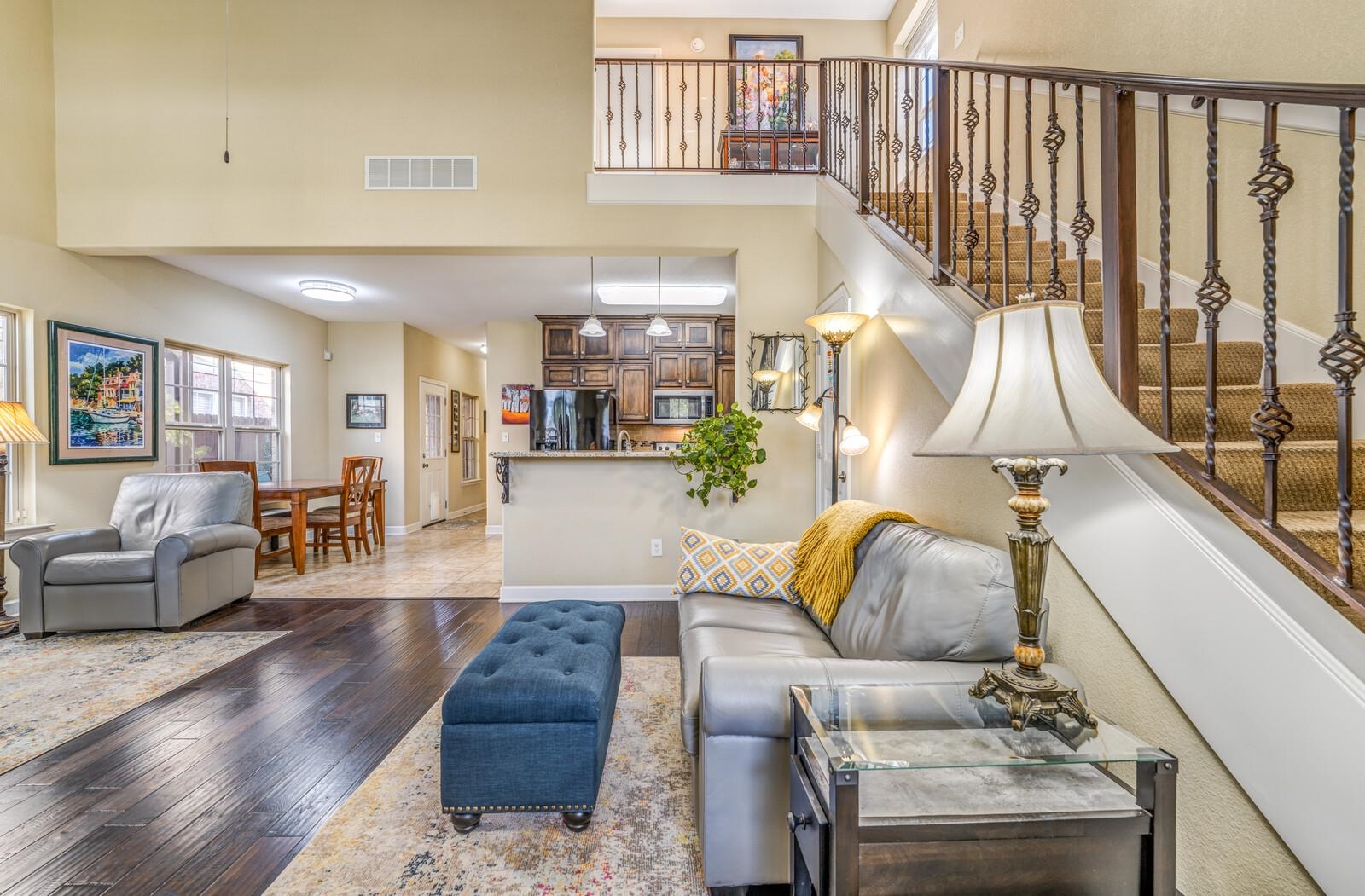 Living room featuring hardwood / wood-style floors and a towering ceiling