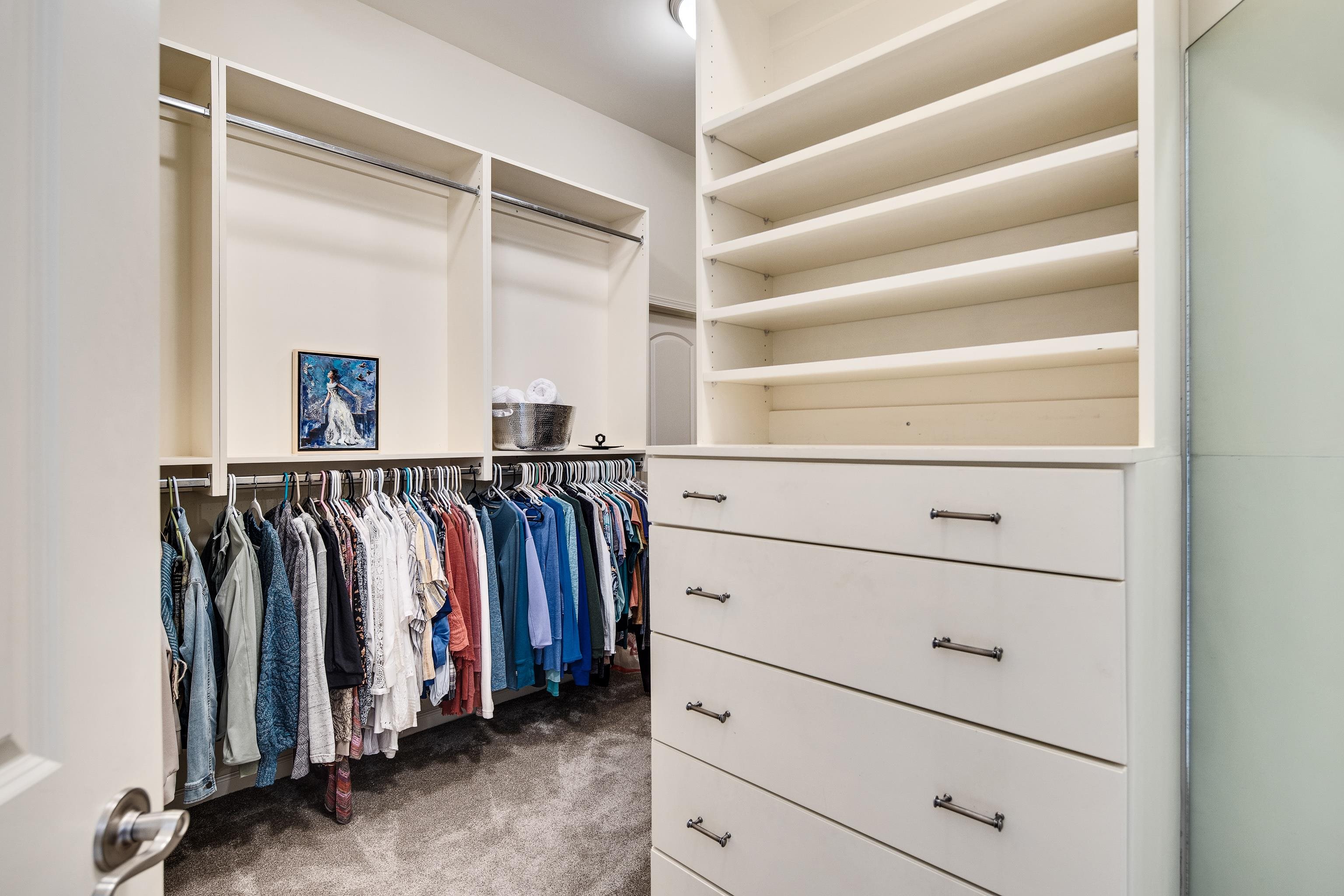 Walk in closet with dark carpet