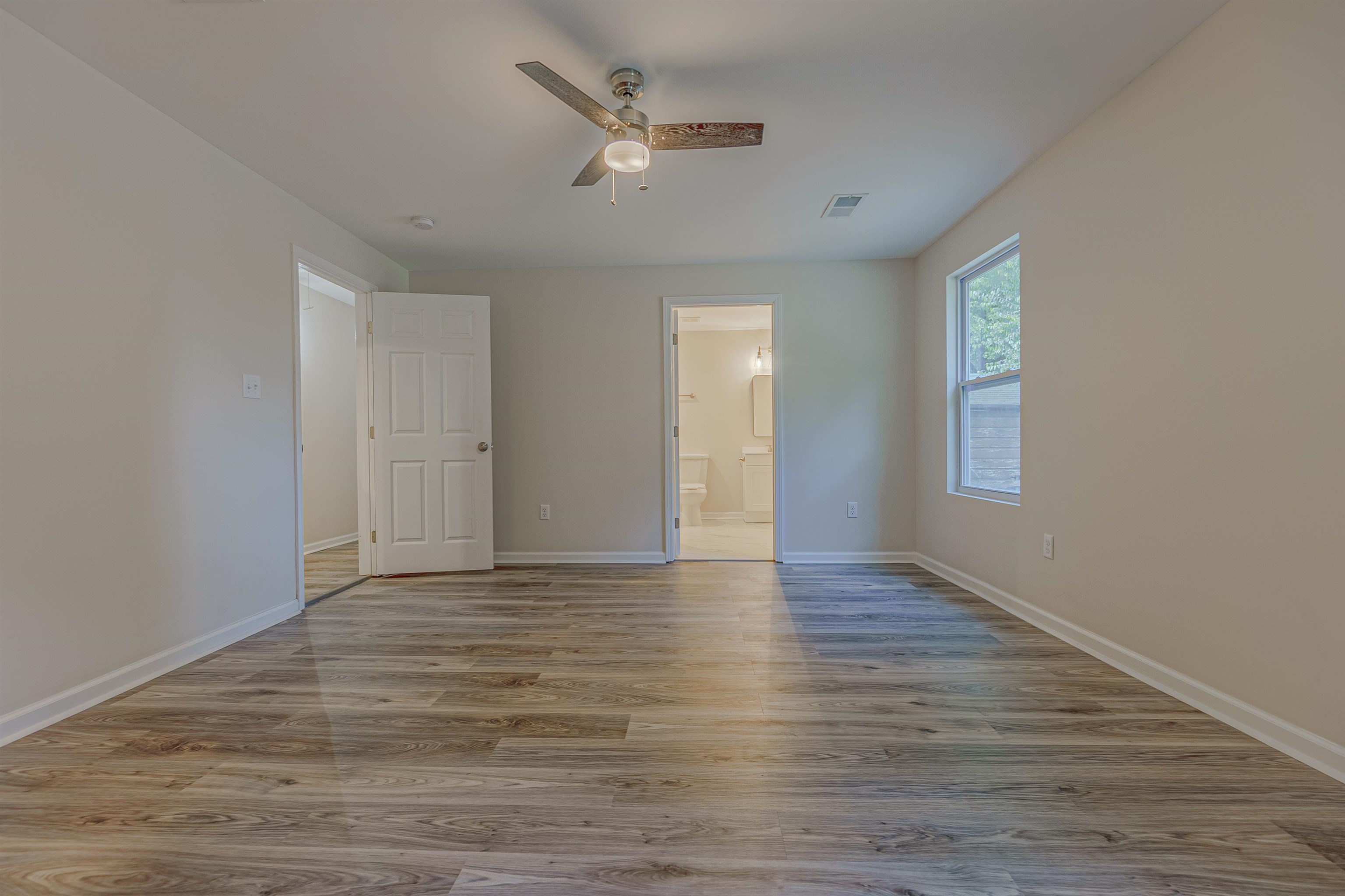 Empty room featuring ceiling fan and light hardwood / wood-style flooring