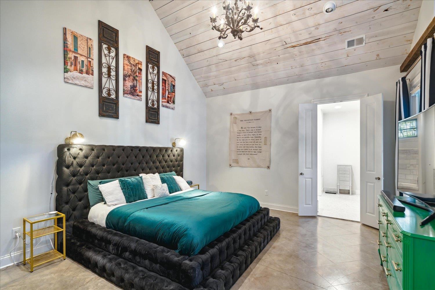 Tiled bedroom with a chandelier, high vaulted ceiling, and wood ceiling