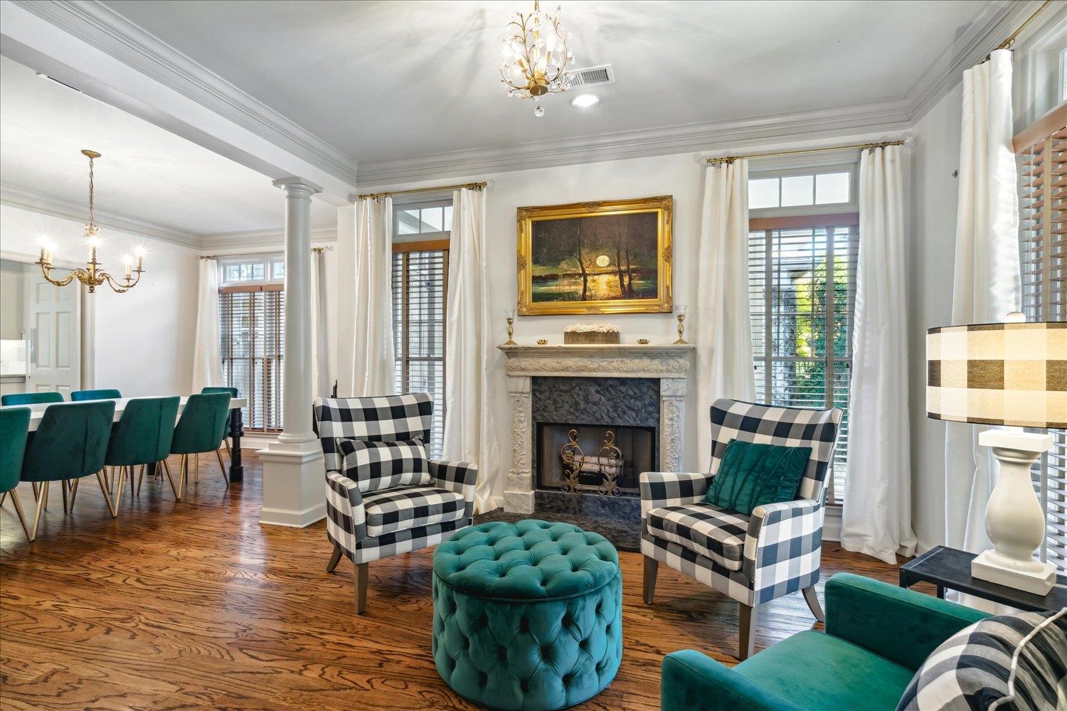 Sitting room featuring hardwood / wood-style flooring, plenty of natural light, crown molding, and a high end fireplace