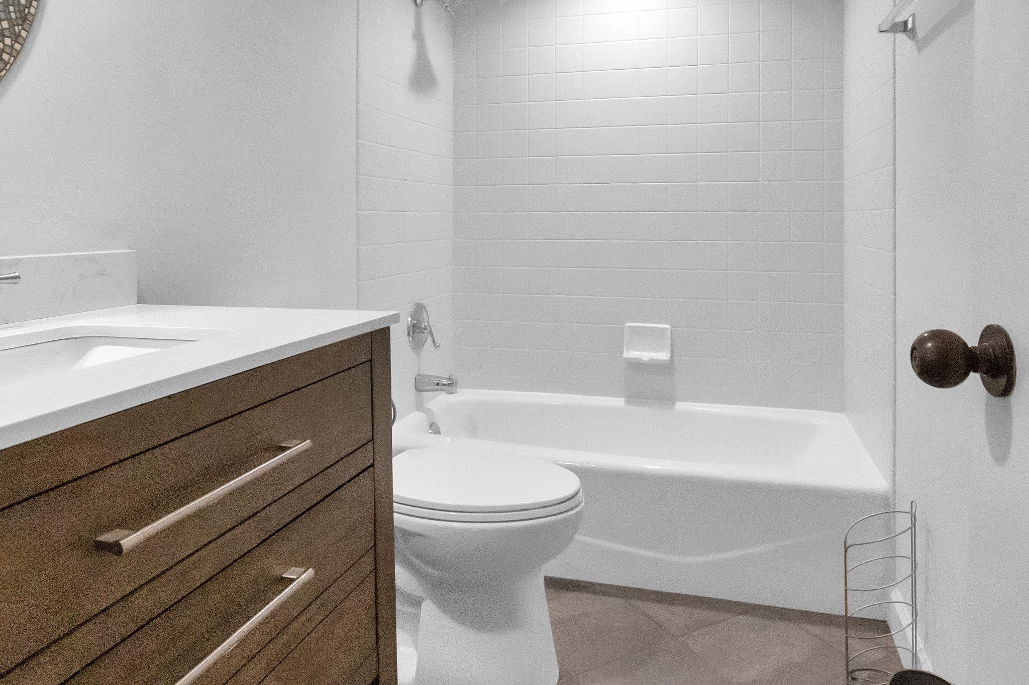 Full bathroom featuring vanity, toilet, and tiled shower / bath