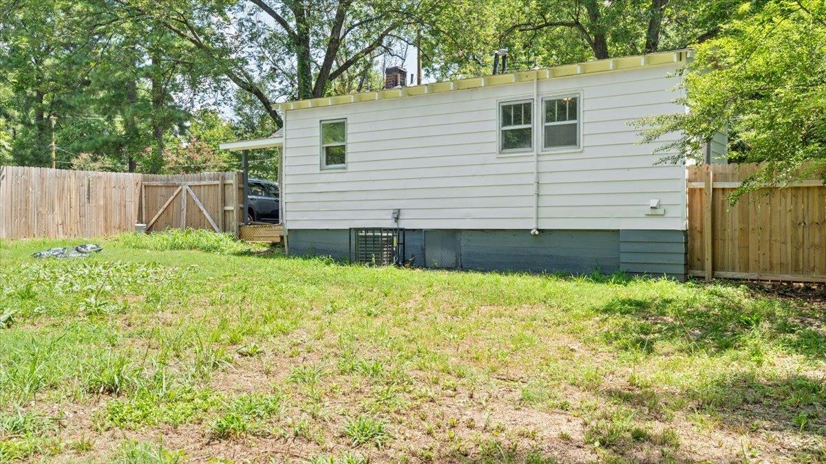 View of side of property with a yard