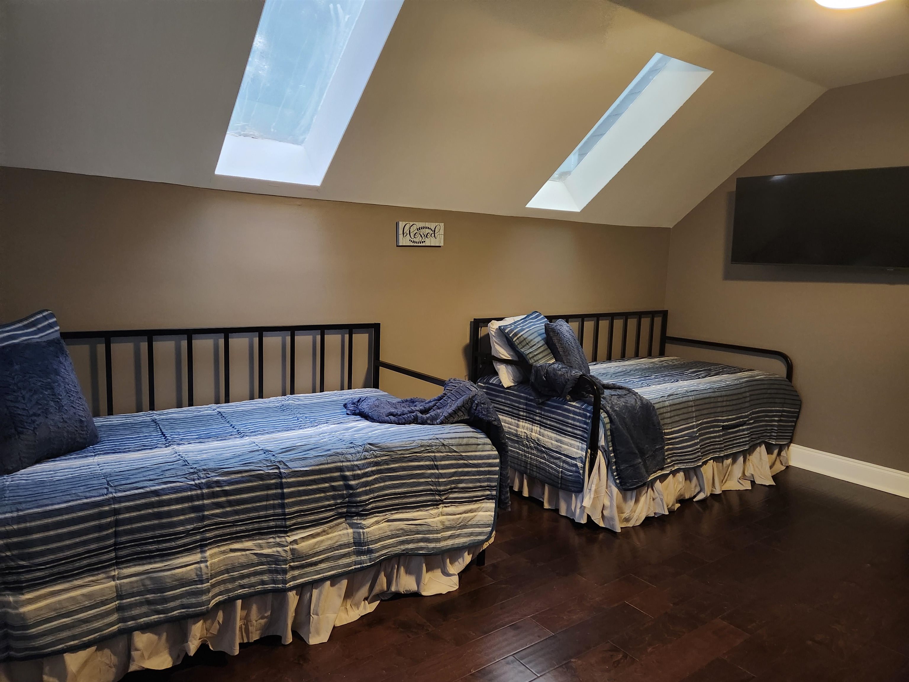 Bedroom with lofted ceiling and hardwood / wood-style flooring