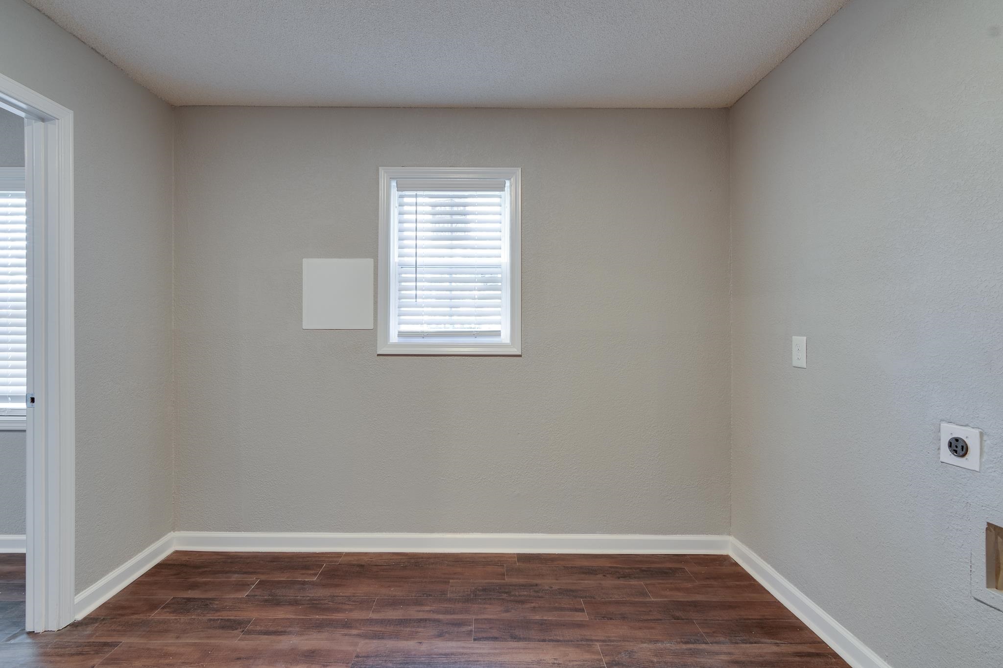 Unfurnished room featuring dark hardwood / wood-style flooring