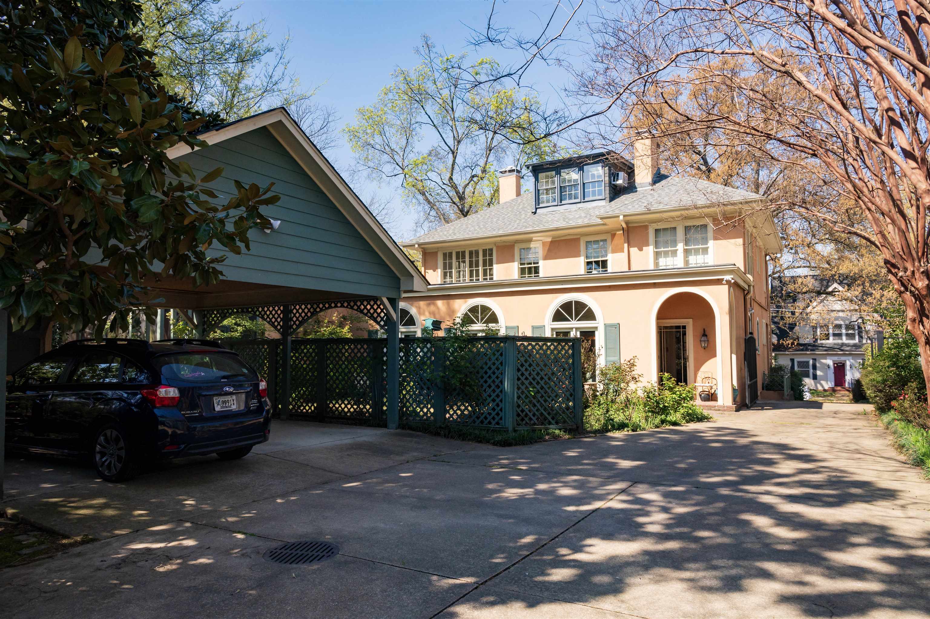 This shot shows the double carport to the left and the gated drive to the right.