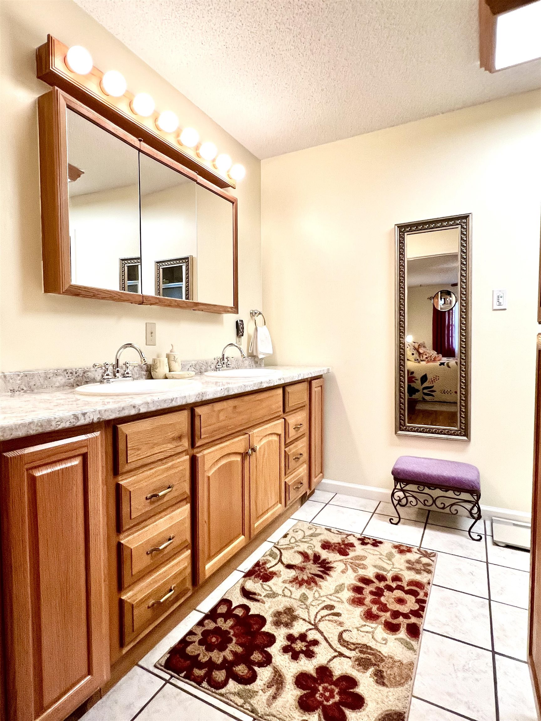 Bathroom featuring vanity, a textured ceiling, and tile patterned floors