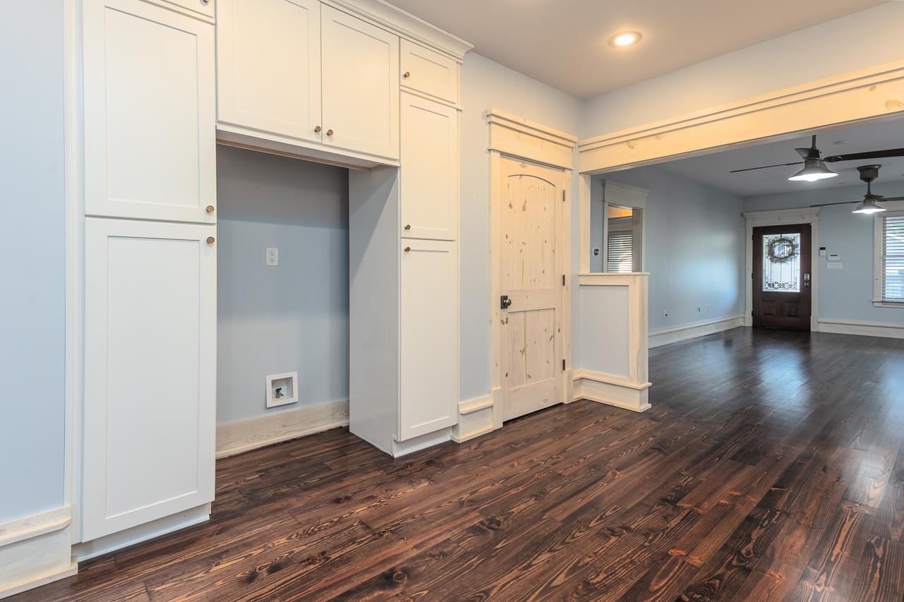 Kitchen with white cabinets, dark hardwood / wood-style floors, and ceiling fan