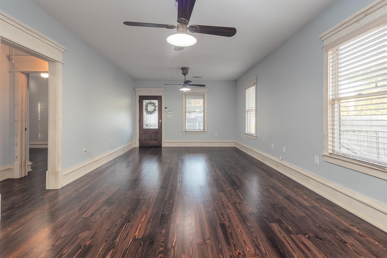Foyer featuring ceiling fan, a healthy amount of sunlight, and dark hardwood / wood-style floors