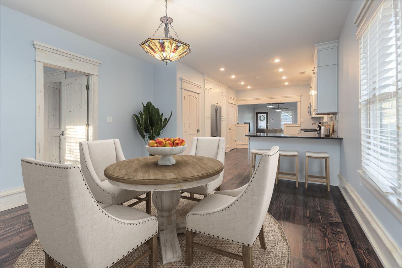 Dining area with ceiling fan and dark hardwood / wood-style flooring