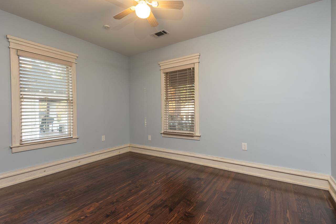 Unfurnished room with hardwood / wood-style floors and ceiling fan